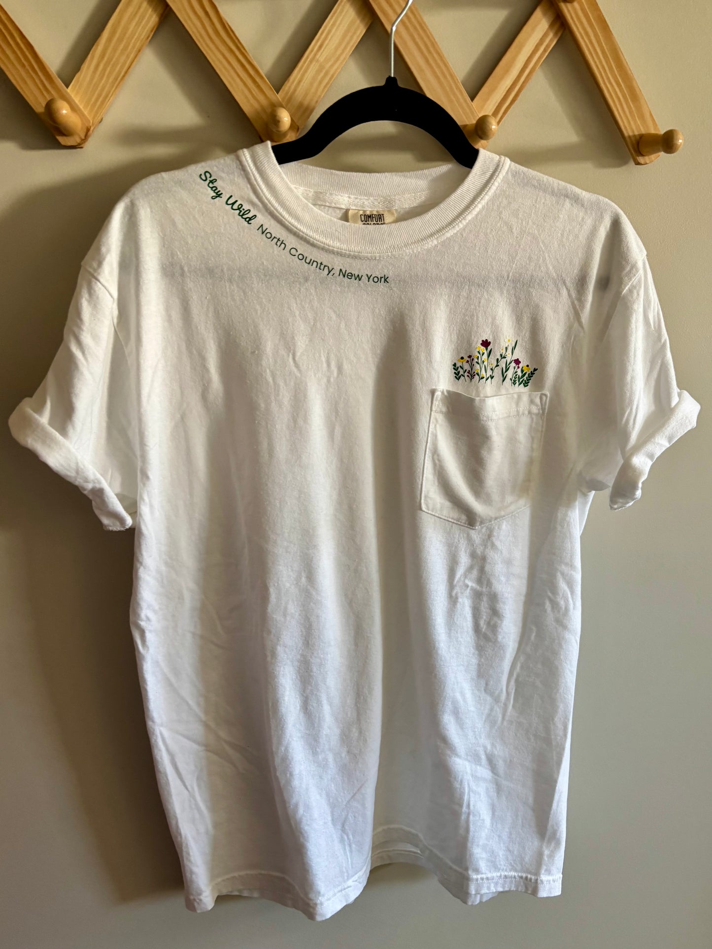 Stay Wild North Country New York Pocket Tee – White Comfort Colors Shirt with Wildflower Design